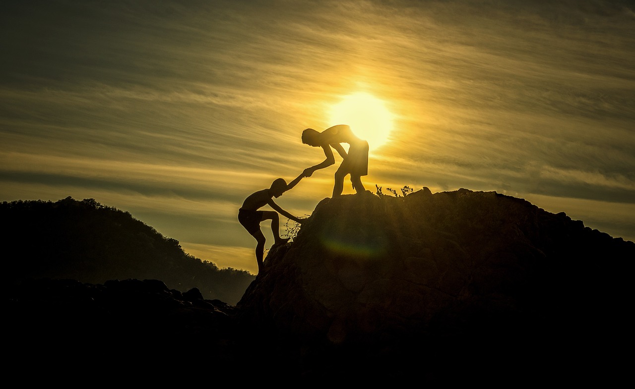two people climbing, symbolizing a tough real estate market